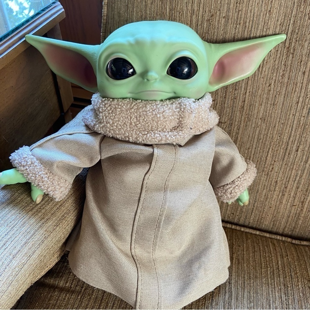STAR Wars character, Baby Yoda has soulful eyes and an enigmatic smile. Iconic!